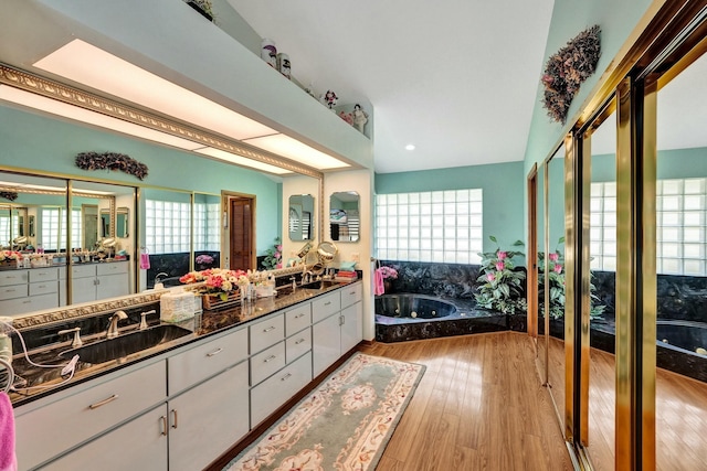 3120 SE Downwinds Rd, Jupiter, FL 33478 - bathroom featuring wood finished floors, double vanity, and a sink
