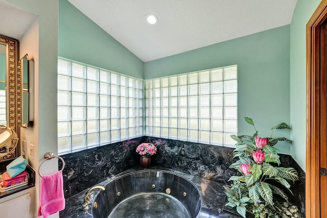 3120 SE Downwinds Rd, Jupiter, FL 33478 - bathroom featuring recessed lighting, a jetted tub, and vaulted ceiling