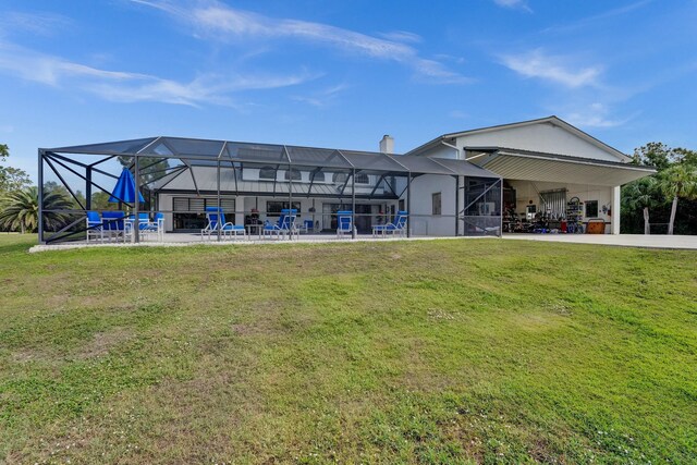 3120 SE Downwinds Rd, Jupiter, FL 33478 - back of property with a chimney, a lanai, a patio, and a yard