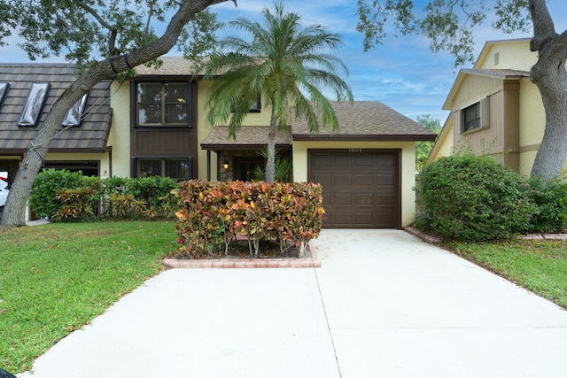 view of front of house with a garage, stucco siding, and concrete driveway