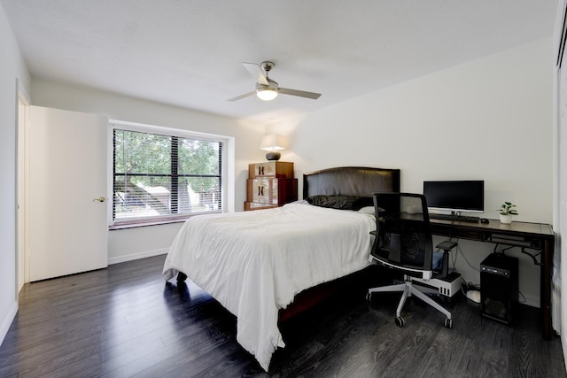 bedroom featuring ceiling fan, dark wood-style flooring, and baseboards