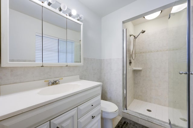 full bathroom with a shower stall, vanity, and toilet