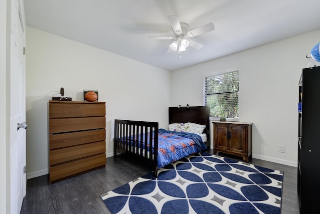 bedroom featuring wood finished floors, baseboards, and a ceiling fan