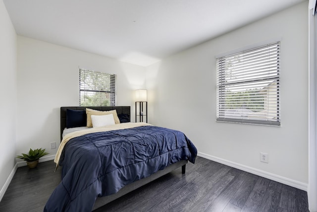 bedroom featuring wood finished floors and baseboards