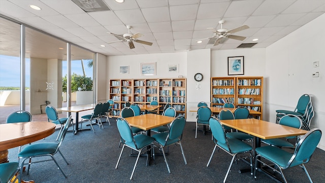136 Lakeshore Dr Unit Ph-13, North Palm Beach, FL 33408 - dining space with a paneled ceiling, ceiling fan, visible vents, and expansive windows