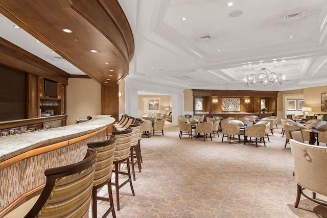 bar featuring coffered ceiling, light colored carpet, a chandelier, a community bar, and visible vents