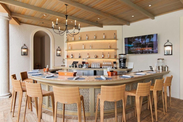 bar with wooden ceiling, beamed ceiling, wet bar, and arched walkways