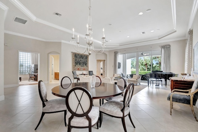 dining area with light tile patterned floors, a raised ceiling, and plenty of natural light