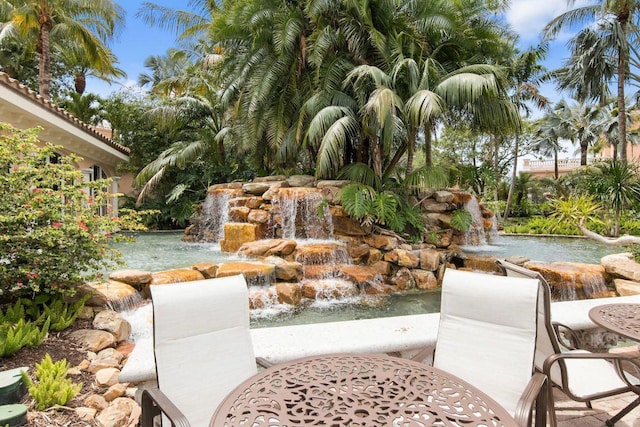 view of patio / terrace with a garden pond