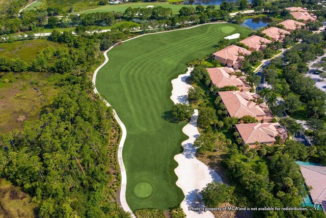 bird's eye view with a water view and view of golf course