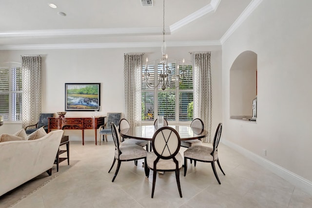dining space with an inviting chandelier, a wealth of natural light, ornamental molding, and arched walkways