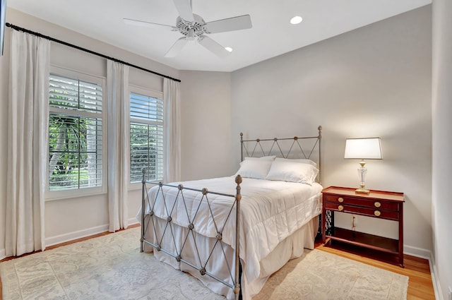 bedroom with wood finished floors, ceiling fan, recessed lighting, and baseboards