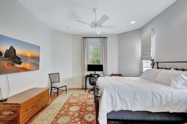bedroom featuring baseboards, recessed lighting, wood finished floors, and ceiling fan