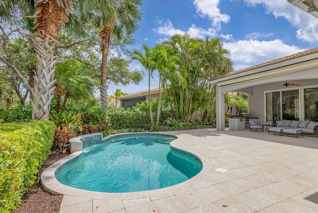 outdoor pool featuring an outdoor living space, ceiling fan, and a patio area