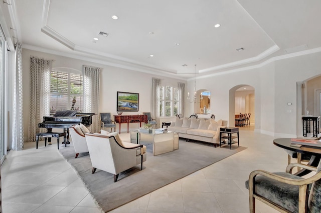 living room featuring light tile patterned floors, arched walkways, ornamental molding, and a raised ceiling