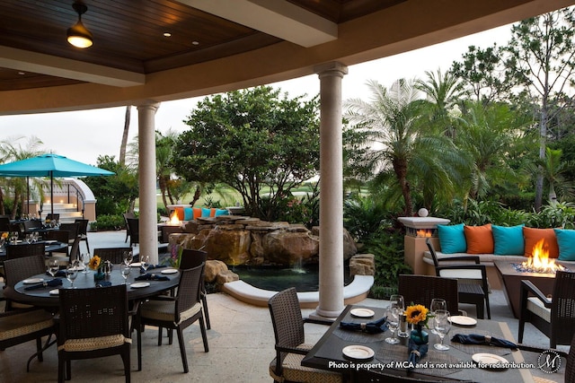 view of patio / terrace with an outdoor fire pit and outdoor dining area