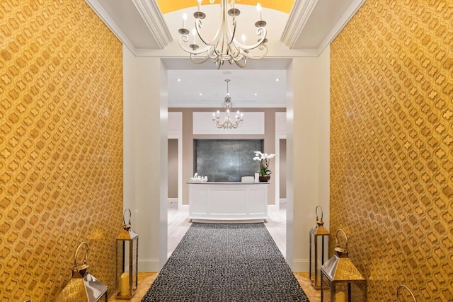 hallway with a chandelier, an accent wall, and crown molding