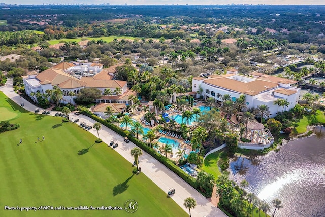drone / aerial view with a water view and golf course view