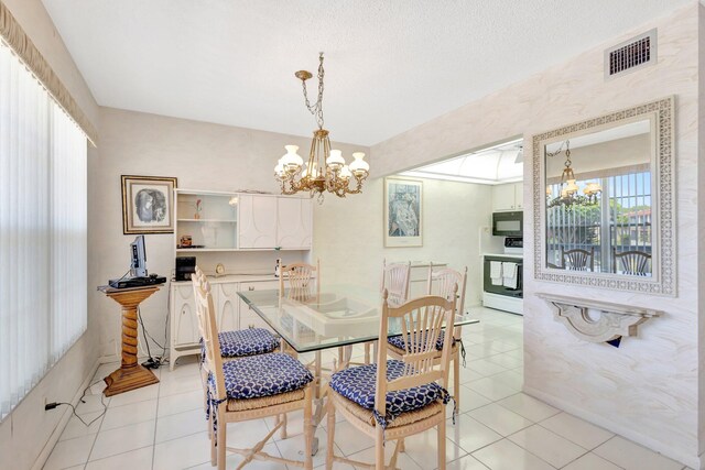 dining space featuring a notable chandelier, visible vents, and light tile patterned flooring