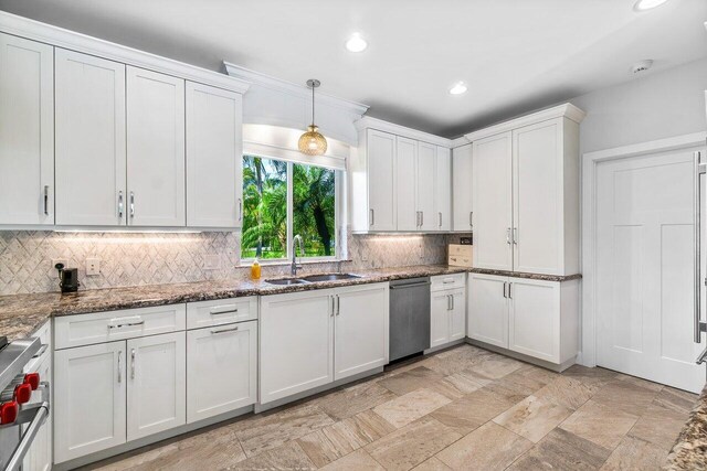 225 NW 11th St, Delray Beach, FL 33444 - kitchen featuring a sink, dishwasher, decorative backsplash, stove, and white cabinets