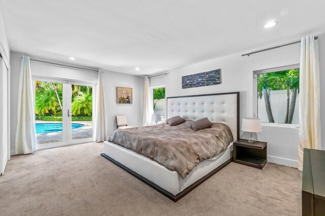 225 NW 11th St, Delray Beach, FL 33444 - bedroom with access to outside, carpet floors, multiple windows, and recessed lighting