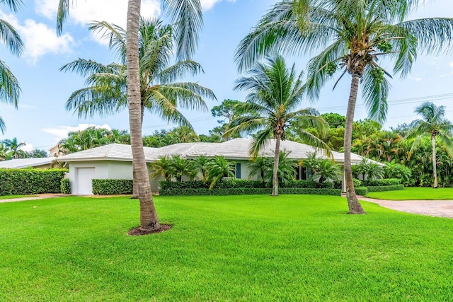 225 NW 11th St, Delray Beach, FL 33444 - view of front of home featuring a front lawn, an attached garage, and stucco siding