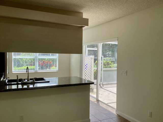 2415 SW Danbury Ln, Palm City, FL 34990 - kitchen with a sink, a textured ceiling, light tile patterned flooring, and a wealth of natural light