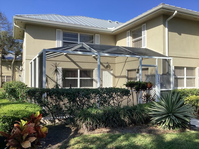 2415 SW Danbury Ln, Palm City, FL 34990 - view of home's exterior with metal roof and stucco siding