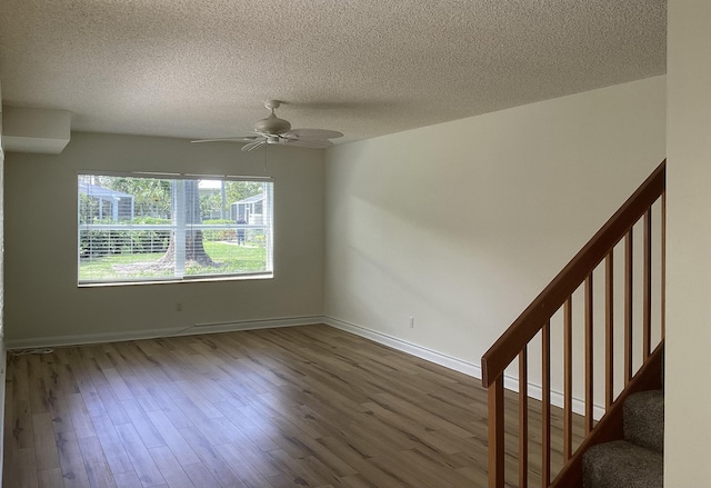 2415 SW Danbury Ln, Palm City, FL 34990 - spare room with a ceiling fan, a textured ceiling, and wood finished floors