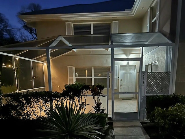 2415 SW Danbury Ln, Palm City, FL 34990 - exterior entry at twilight with stucco siding