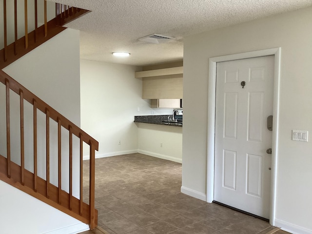 2415 SW Danbury Ln, Palm City, FL 34990 - interior space with tile patterned floors, baseboards, a textured ceiling, and visible vents
