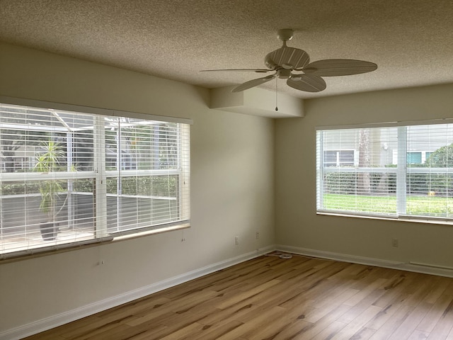 2415 SW Danbury Ln, Palm City, FL 34990 - spare room with baseboards, a ceiling fan, a textured ceiling, and wood finished floors