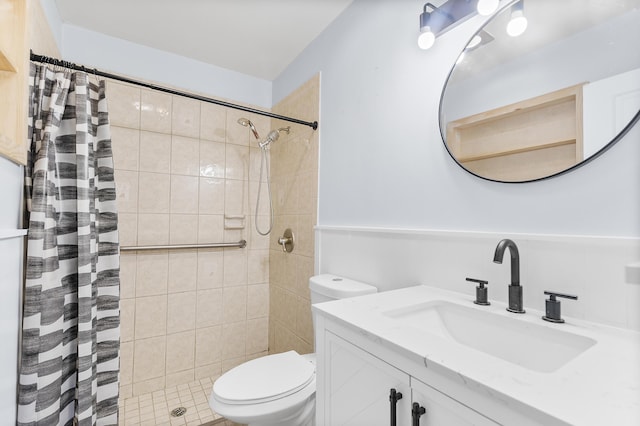 bathroom featuring toilet, a tile shower, and vanity