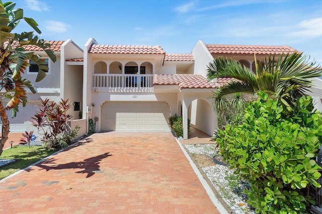 126 Harbor Cir, Delray Beach, FL 33483 - mediterranean / spanish-style home featuring a tiled roof, stucco siding, decorative driveway, a balcony, and an attached garage