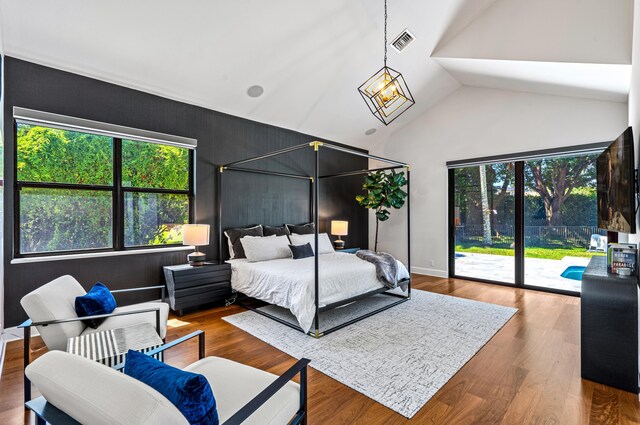 bedroom featuring access to outside, wood finished floors, and visible vents
