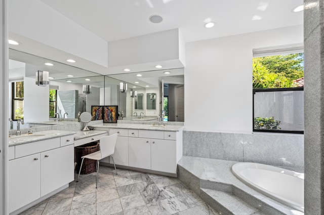 bathroom featuring a bath, marble finish floor, vanity, and recessed lighting
