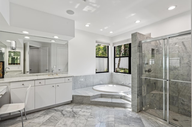 bathroom featuring recessed lighting, marble finish floor, vanity, a bath, and a stall shower