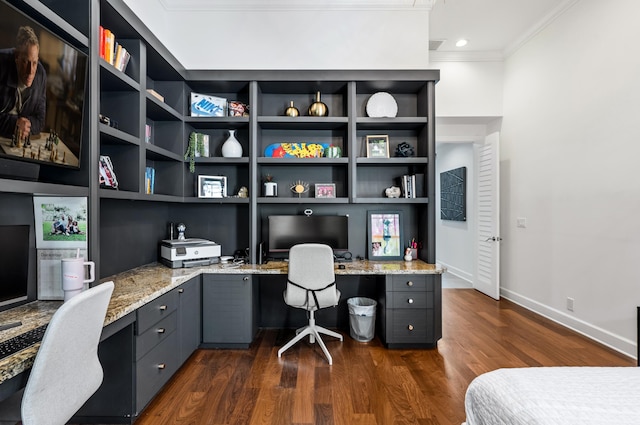 office area featuring built in study area, baseboards, ornamental molding, and dark wood-style floors