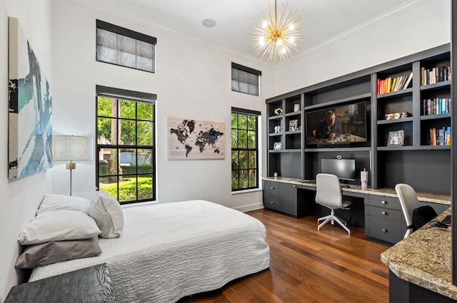 bedroom featuring built in desk, crown molding, and dark wood-type flooring