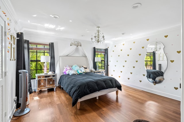 bedroom featuring ornamental molding, wood finished floors, and a chandelier