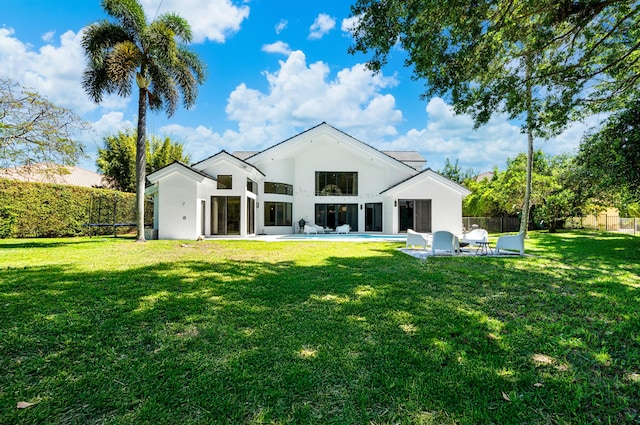 back of property with a patio area, a lawn, a fenced backyard, and stucco siding