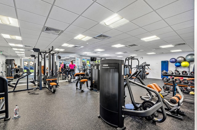 exercise room with visible vents and a paneled ceiling