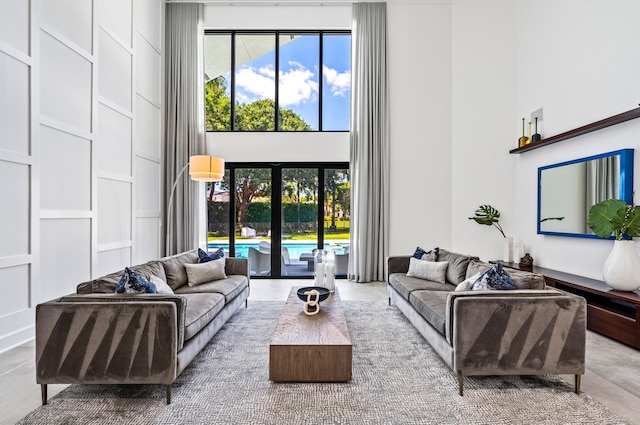 living room with a high ceiling and a wealth of natural light