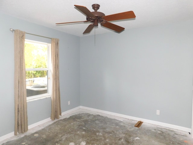 17609 72nd Rd N, The Acreage, FL 33470 - empty room featuring concrete flooring, baseboards, and ceiling fan
