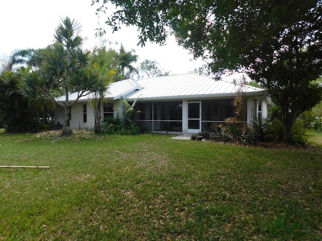 17609 72nd Rd N, The Acreage, FL 33470 - back of property featuring a standing seam roof, a yard, metal roof, and a sunroom