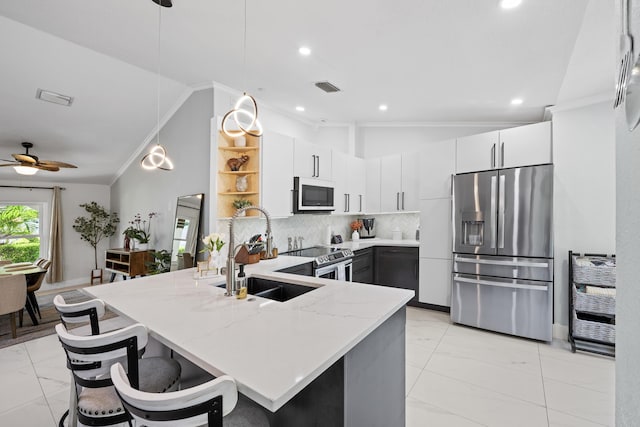 kitchen with visible vents, a sink, light stone countertops, marble finish floor, and stainless steel appliances