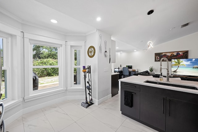 kitchen with visible vents, a sink, light countertops, dark cabinetry, and marble finish floor