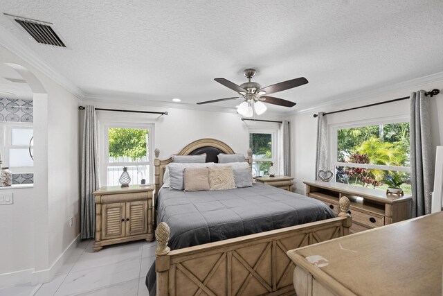 bedroom featuring crown molding, arched walkways, visible vents, marble finish floor, and baseboards