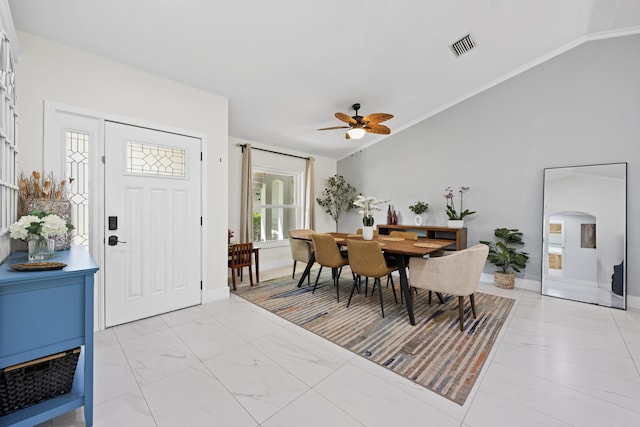 dining room featuring visible vents, baseboards, a ceiling fan, and vaulted ceiling