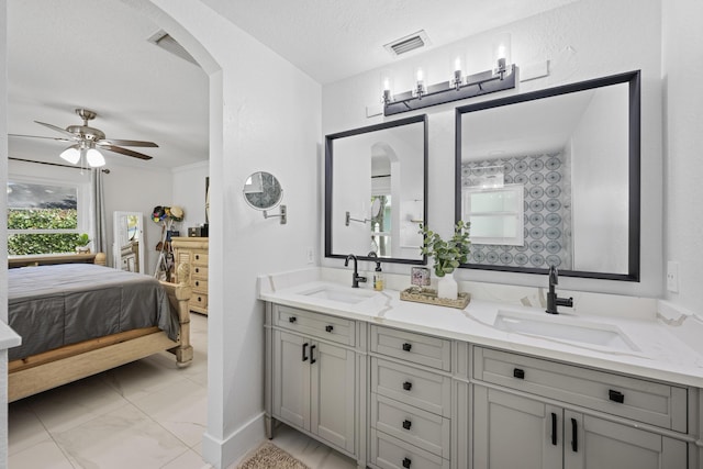 ensuite bathroom featuring ensuite bathroom, visible vents, a sink, and a healthy amount of sunlight